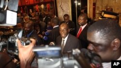 Zimbabwean President Robert Mugabe (C) briefs journalists after meeting with Prime Minister Morgan Tsvangirai and South African President Jacob Zuma on the progress made on the implementation of The Global Political Agreement ahead of anticipated election