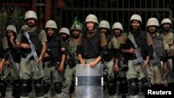 Ranger soldiers stand guard against anti-government protesters rallying near the parliament building in Islamabad, Aug. 20, 2014. 