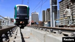 FILE - A worker walks along a metro line construction project in Addis Ababa, Ethiopia, Feb. 7, 2015. 