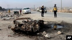 Syrian White Helmet civil defense workers inspect the area of a car bomb attack that killed least 15 people and wounded dozens, the local Syrian civil defense reported, near Manbij, Syria, Feb. 3, 2025. (Syrian Civil Defense White Helmets via AP)