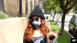 Phoebe Price wears a face mask and gloves amid fears of the coronavirus in Los Angeles, Calif., March 31, 2020. 