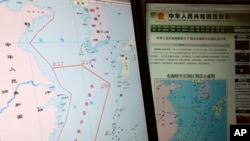 Computer screens display map showing outline of China's new air defense zone in the East China Sea, website of Chinese Ministry of Defense, Beijing, Nov. 26, 2013.