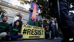 GreenPeace activists demonstrate outside a hotel hosting a G7 Energy meeting in Rome, Italy, April 10, 2017.