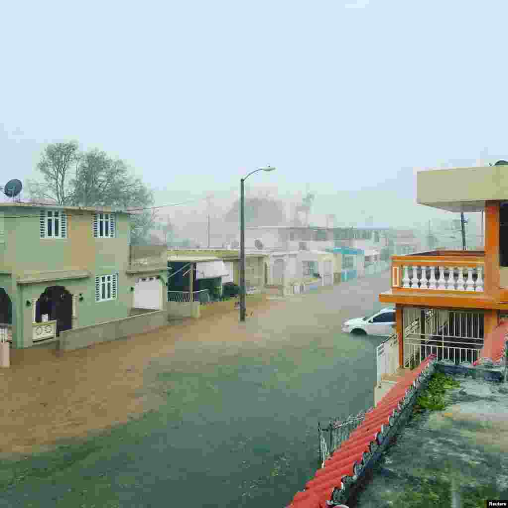 A flooded road is seen after Hurricane Maria hit Puerto Rico, Sept. 20, 2017, in this still image taken from social media. 