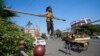 Maria, a 6 years old girl state tight rope walking to attract alms from people in Prayagraj, Uttar Pradesh, India, Thursday, Dec. 5, 2024.(AP Photo)