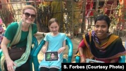 Sasha Forbes, left, and her 9-year-old daughter Maya, middle, meet their sponsored girl in Khulna, Bangladesh, April 2018.