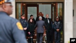 Pittsburgh police stand guard as the casket of Irving Younger, 69, is wheeled from Congregation Rodef Shalom after his funeral in Pittsburgh, Oct. 31, 2018. 