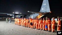In this photo released by Inter Services Public Relations, Pakistan Army's Urban Search and Rescue team members board a plane for the departure to Turkey to help rescue operation in earthquake hit areas, at Nur Khan airbase in Rawalpindi, Pakistan, Feb. 7, 2023.