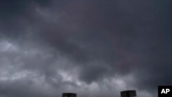 Storm clouds hover over the Fukushima Azuma Baseball Stadium at the 2020 Summer Olympics, July 27, 2021, in Fukushima, Japan. 