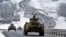 A convoy of Russian armored vehicles moves along a highway in Crimea, Jan. 18, 2022.