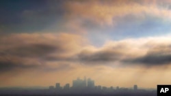 FILE - In this Oct. 26, 2018, file photo, downtown Los Angeles is shrouded in early morning coastal fog and smog.