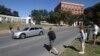 Tourists gather on the street where President John F. Kennedy's was shot from 6th floor of the book depository at Dealey Plaza in downtown Dallas, Oct. 25, 2017. 