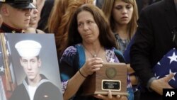 Elizabeth Strange, center, carries her son's remains,at a flag presentation ceremony for U.S. Navy Petty Officer 1st Class Michael Joseph Strange, in Philadelphia on August18, 2011. Strange was assigned to the Navy SEAL team whose Chinook helicopter was s