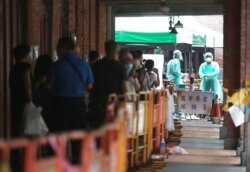 FILE - People line up at a coronavirus testing center after the COVID-19 alert rose to Level 3 in Taipei, Taiwan, May 18, 2021.