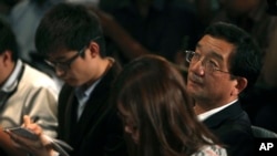 Chinese Ambassador to Malaysia Huang Huikang, right, listens during a press conference at a hotel in Sepang, Malaysia, March 12, 2014