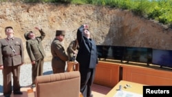 North Korean leader Kim Jong Un looks on during the test-launch of the intercontinental ballistic missile Hwasong-14 in this undated photo released by North Korea's Korean Central News Agency (KCNA) in Pyongyang July 5, 2017. KCNA/via REUTERS 