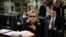 FILE - Then-Secretary of State Hillary Rodham Clinton checks her Blackberry from a desk inside a C-17 military plane upon her departure from Malta, in the Mediterranean Sea, bound for Tripoli, Libya, Oct. 18, 2011. Clinton used a personal email account during her time as secretary of state, rather than a government-issued email address, potentially hampering efforts to archive official government documents required by law.