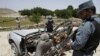 Afghan policemen examine the remains of a damaged vehicle after it was hit by a roadside bomb in the Deh Bala district of Jalalabad east of Kabul, Afghanistan, May 30, 2012.