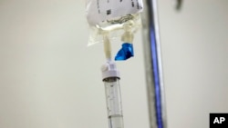 FILE - Chemotherapy drugs are administered to a cancer patient at a hospital in Chapel Hill, N.C., May 25, 2017.
