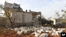 People check a destroyed house after an operation by the U.S. military in the Syrian village of Atmeh, in Idlib province, Syria, Feb. 3, 2022.
