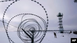 A Ukrainian border guard patrols the border with Russia not far from Hoptivka village, Kharkiv region, Ukraine, Feb. 2, 2022.