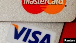 FILE - MasterCard and VISA credit cards are seen in this illustrative photograph taken in Hong Kong, Dec. 8, 2010.