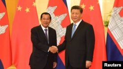 FILE: Cambodia’s Prime Minister Hun Sen shakes hands with China's President Xi Jinping before their meeting at the Great Hall of the People in Beijing, China April 29, 2019. Madoka Ikegami/Pool via REUTERS