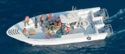 This image released by the U.S. Department of Defense on June 17, 2019, shows what the Navy says is the Islamic Revolutionary Guard Corps Navy after removing an unexploded mine from a tanker in the Strait of Hormuz.