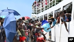 Voters board the already overcrowded Fair Glory ferry in Honiara, Solomon Islands, April 13, 2024, heading to Malaita Island to vote in a national election. The country in which China has gained most influence in the South Pacific goes to the polls on Wednesday.