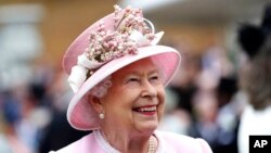FILE - Britain's Queen Elizabeth arrives for a Royal Garden Party at Buckingham Palace in London, May 29, 2019.