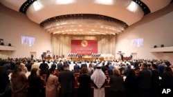 FILE - Newly elected lawmakers attend their first parliament session, in Baghdad, Iraq, Jan. 9, 2022. (Iraqi Parliament Media Office via AP) 