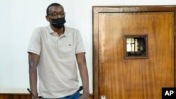 FILE - Ugandan author Kakwenza Rukirabashaija appears before a court in a failed bid to have his passport returned, in Kampala, Uganda, Feb. 1, 2022.