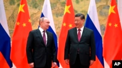 រូបឯកសារ៖ ប្រធានាធិបតី​ចិន លោក Xi Jinping (ស្ដាំ) និង​ប្រធានាធិបតី​រុស្ស៊ី លោក Vladimir Putin ឈរ​ថតរូប​ជាមួយ​គ្នា​នៅ​មុន​ជំនួប​របស់​ពួកគេ​នៅ​ទីក្រុង​ប៉េកាំង ប្រទេស​ចិន ថ្ងៃទី៤ ខែកុម្ភៈ ឆ្នាំ២០២២។ (Alexei Druzhinin, Sputnik, Kremlin Pool Photo via AP)