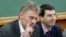 Russian President Vladimir Putin's spokesman Dmitry Peskov, left, speaks during a meeting in Moscow, Russia, Dec. 9, 2012. 