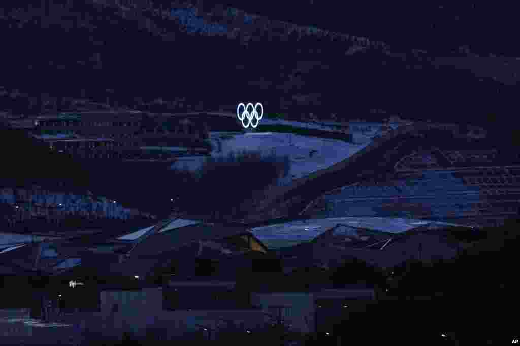 The Olympic rings shine near cross-country skiing training, Feb. 2, 2022, in Zhangjiakou, China.