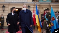 Ukrainian President Volodymyr Zelenskyy, left, and Turkey's President Recep Tayyip Erdogan review the honour guard during a welcome ceremony ahead of their meeting in Kyiv, Ukraine, Feb. 3, 2022.