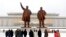 People visit the statues of former North Korean leaders Kim Il Sung, left, and Kim Jong Il on Mansu Hill in Pyongyang, North Korea, on the occasion of Lunar New Year holidays on Feb. 1, 2022.