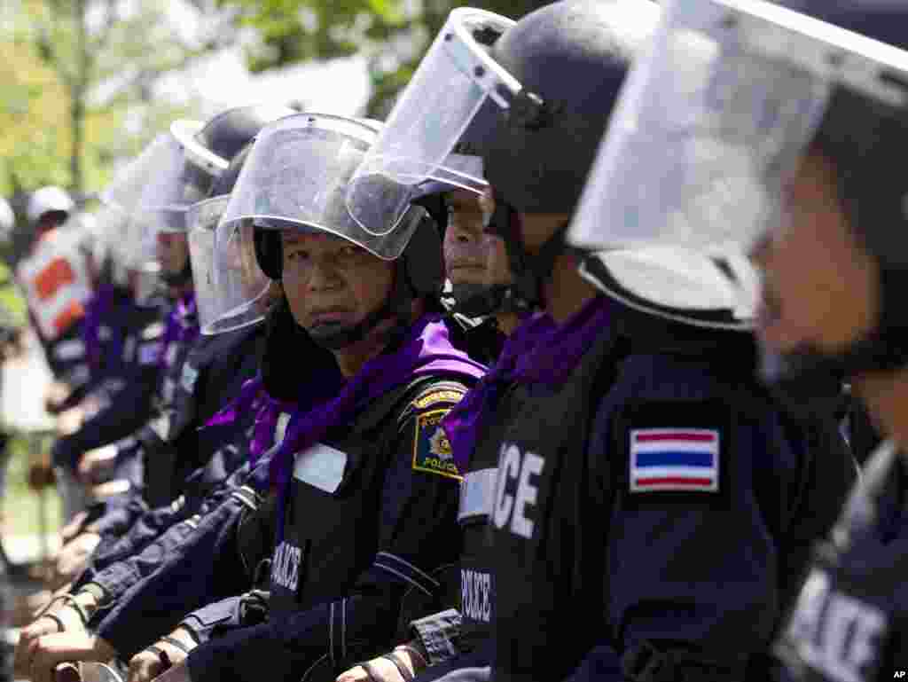 Riot police stand guard outside an air force academy compound that anti-government protesters had entered earlier in Bangkok, May 15, 2014.