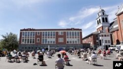 Church parishioners sit apart at a prayer vigil for racial justice at Immaculate Conception Catholic Church, July 19, 2020, in Seattle. 
