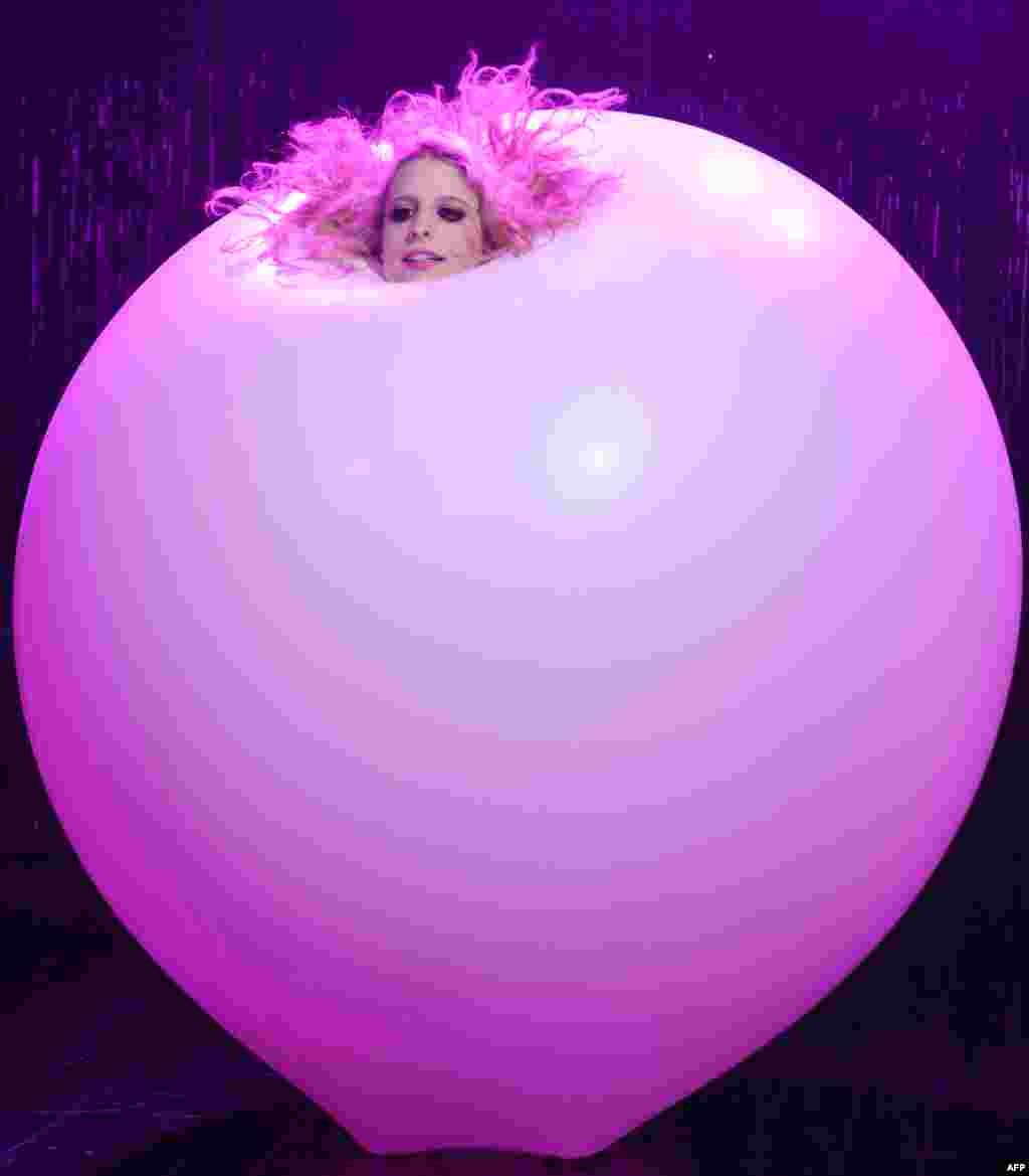 Australian artist Jaimi Luthrmann performs in a giant balloon in the Blanc De Blanc Champagne Circus at the Sydney Opera House.