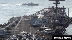 FILE - U.S. aircraft carrier USS Carl Vinson arrives for an annual joint military exercise called "Foal Eagle" between South Korea and U.S, at the port of Busan, South Korea, March 15, 2017. 