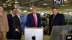 President Donald Trump tours an Apple manufacturing plant, Nov. 20, 2019, in Austin, Texas, with Apple CEO Tim Cook, third from left. 