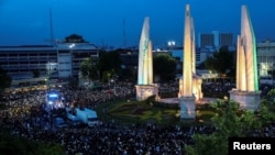 Pro-democracy protesters use mobile phones as flashlights as they attend a rally to demand the government to resign, to dissolve the parliament and to hold new elections under a revised constitution, near the Democracy Monument in Bangkok, Thailand, Augus