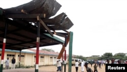 Residents walk near the scene of an explosion targeting a political dias in Kenya's northern town of Garissa, February 17, 2013. 