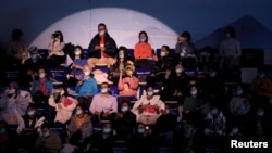 Spectators wear masks for protection against COVID-19 at a curling match in National Aquatics Center, Beijing, China, Feb. 8, 2022. 