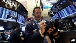 Trader Gregory Rowe on the floor of the New York Stock Exchange, May 28, 2013.
