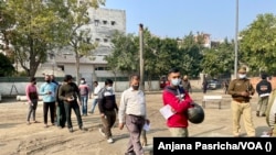 People line up to cast votes in Nodia, a town in Uttar Pradesh that adjoins the Indian capital, Feb. 10, 2022. 