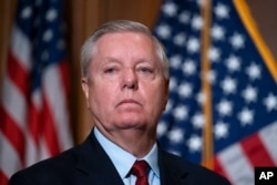FILE - Sen. Lindsey Graham, R-S.C., waits to speak to reporters at the Capitol in Washington, Feb. 10, 2022.