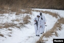 Members of the Ukrainian State Border Guard Service patrol the area near the frontier with Russia in the Chernihiv region, Ukraine, Feb. 16, 2022.