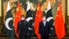 FILE - In this photo released by Xinhua News Agency, Chinese President Xi Jinping, right, and Pakistan Prime Minister Imran Khan pose for a photo before their bilateral meeting at the Great Hall of the People in Beijing, Feb. 6, 2022. 
